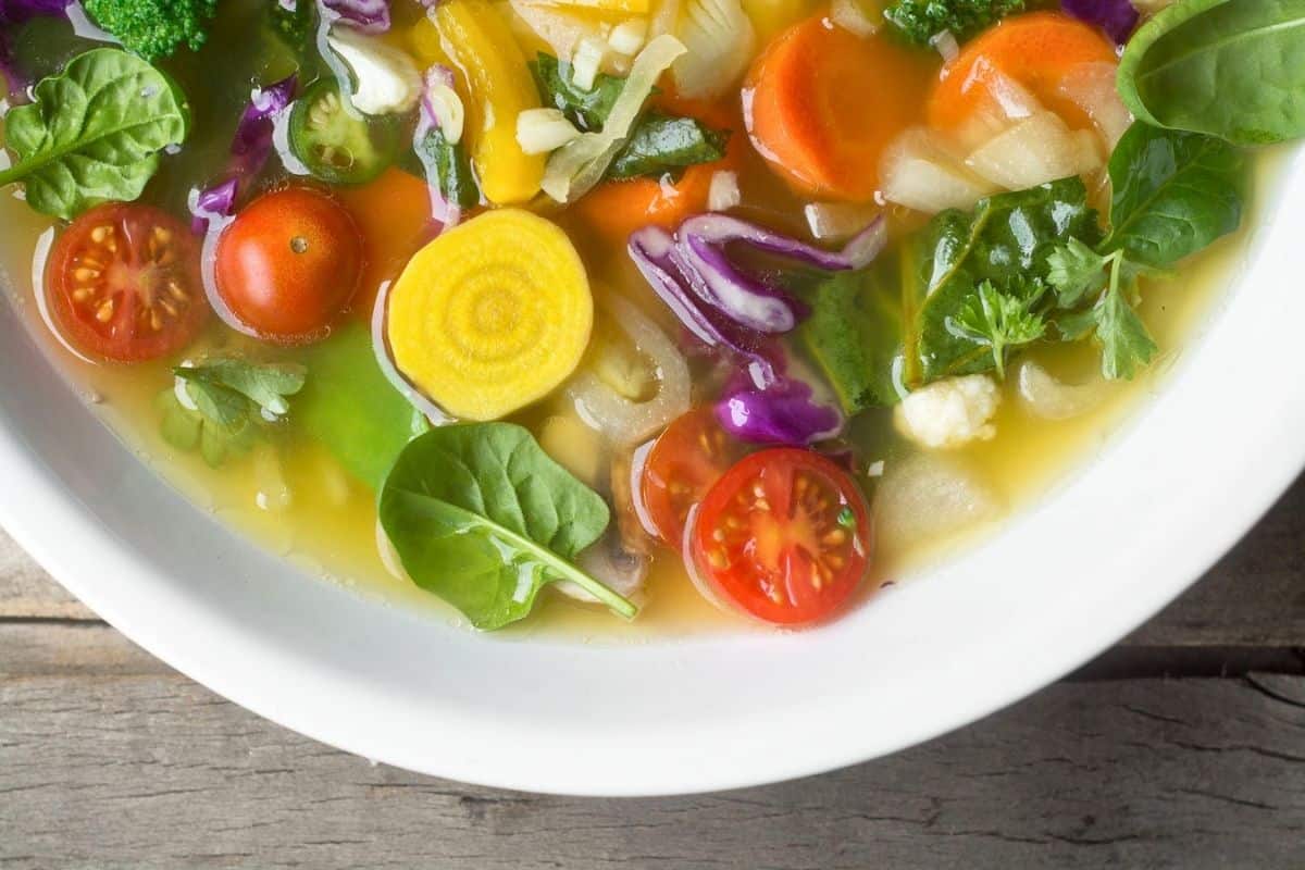 Brothy veggie soup in a bowl.