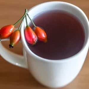 a mug of rose hip tea brewed from fresh rose hips.